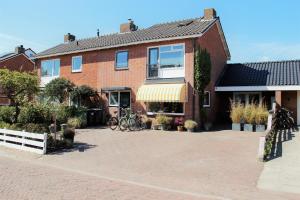 a brick house with a large driveway in front of it at Southpoint Zandvoort with free parking in Zandvoort