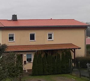 a large house with a large garage in front of it at Ferienwohnung „Thea“ in Bad Lausick