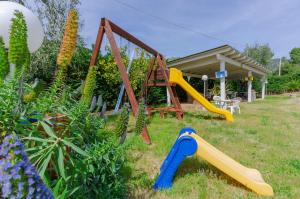 a playground with two slides and a swing at B&B Tor Di Lupo in Mattinata