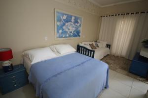 מיטה או מיטות בחדר ב-Recanto Villa REAL