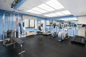 a gym with several treadmills and machines in a room at Cayman Suites Hotel in Ocean City