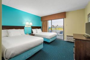 Postel nebo postele na pokoji v ubytování Cayman Suites Hotel + 37 fotografií