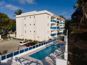 an aerial view of a building with a swimming pool at CoralK Apartments Sosúa in Sosúa