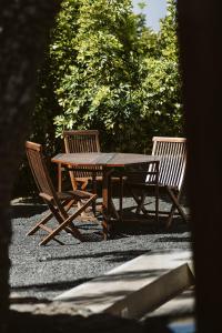 
a wooden table with chairs and a table cloth at Hotelito Rural Flor de Timanfaya in Tinajo
