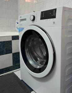 a white washing machine sitting in a bathroom at Ploiesti ultracentral !!! in Ploieşti