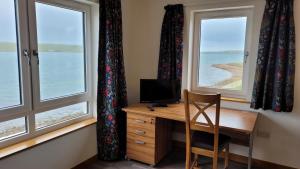 a room with a desk with a computer and two windows at VitaVer, B&B, STL-OR00012F in Orkney