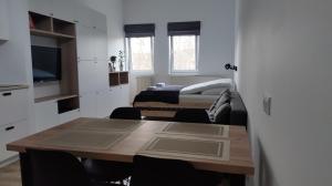 a room with a table and a room with two beds at Apartament 4 Piętro in Sopot