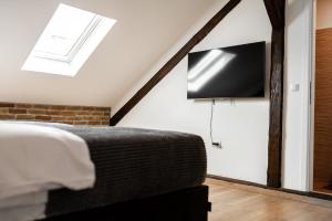 a bedroom with a bed and a tv on the wall at DreamHouse7 rooms in Zagreb