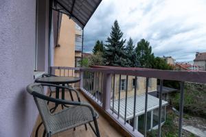 a balcony with a table and a chair on a balcony at DreamHouse7 rooms in Zagreb