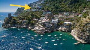 an island with a yellow arrow pointing into the ocean at Villa Marunnella in Praiano