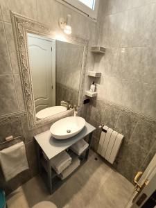 a bathroom with a sink and a mirror at Luxury Family Homes K in Salamanca