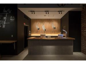 a counter with drawings of birds on the wall at Kamon Hotel Namba - Vacation STAY 37041v in Osaka