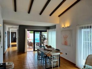 a dining room with a table and chairs in a room at Beautiful spacious villa with private heated pool in Lajares in Lajares