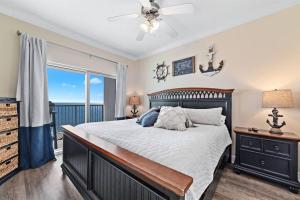 a bedroom with a large bed and a balcony at Crystal Tower 1408 - Lazy River, Beachfront pool, Amazing Views, New Upgrades!! in Gulf Shores