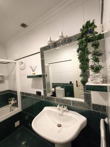 a bathroom with a sink and a mirror at Luxury Family Homes K in Salamanca