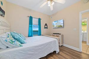 a bedroom with a bed and a ceiling fan at Crystal Tower 1408 - Lazy River, Beachfront pool, Amazing Views, New Upgrades!! in Gulf Shores