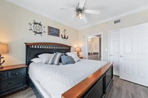 a bedroom with a bed and a ceiling fan at Crystal Tower 1408 - Lazy River, Beachfront pool, Amazing Views, New Upgrades!! in Gulf Shores