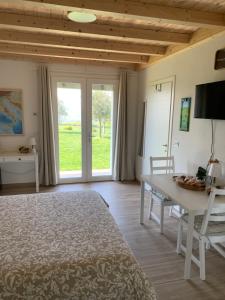 a bedroom with a bed and a table and a window at B&B La Casa Del Sole in Sala Baganza