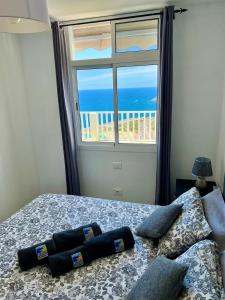 a bedroom with a bed with a view of the ocean at Canarias Sunshine Amadores in Amadores