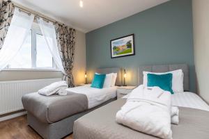 a bedroom with two beds and a window at The Hideaway @ Watergate eye Farm in Barnard Castle