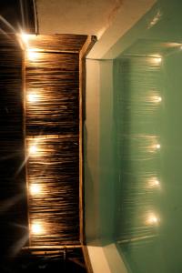 a bathroom with a glass shower with lights on it at Esquina Lejana EcoLodge in Palomino +46 photos