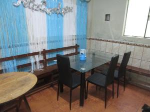 una sala da pranzo con tavolo in vetro e sedie di jazmines point a Lima