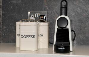 a coffeemaker and a coffee maker sitting on a counter at Garden Mews - 2 double bedrooms - Harrogate Holiday Apartments in Harrogate