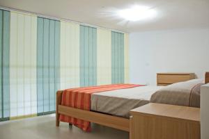 Кровать или кровати в номере Appartamento Reginella
