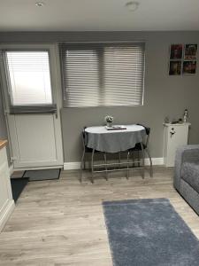 a living room with a table and a couch at Lytham Sea Salt Lodge in Lytham St Annes