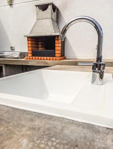 a white sink in a kitchen with a stove at Caleta de Interian Loft Sasy in Los Silos