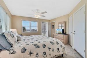 a bedroom with a bed and a ceiling fan at Summer Breeze #25 - Modest Beachfront with views of the Pass! Great Location! in Orange Beach