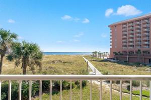 a view of the beach from the balcony of a hotel at Summer Breeze #25 - Modest Beachfront with views of the Pass! Great Location! in Orange Beach