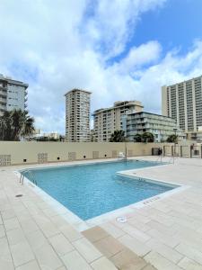 a swimming pool with buildings in the background at Royal Kuhio Resort in Honolulu