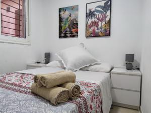 1 dormitorio con 1 cama con toallas en Los Cristianos - heated swimming pool air-conditioned en Los Cristianos