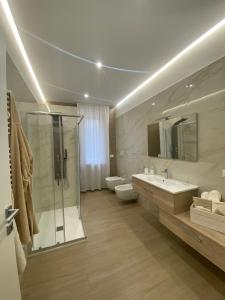a bathroom with a shower and a toilet and a sink at Cà Sal Holiday Home in Lesina