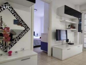 a living room with a mirror and a television at Los Cristianos - heated swimming pool air-conditioned in Los Cristianos