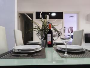 a dining room table with a bottle of wine and glasses at Los Cristianos - heated swimming pool air-conditioned in Los Cristianos