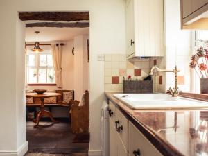 a kitchen with a sink and a table in a room at Bastle House in Haltwhistle