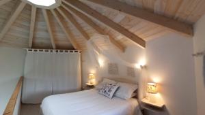 sypialnia z białym łóżkiem i 2 lampami w obiekcie Mini casa con jardín w mieście Mungia