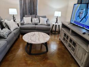 a living room with a couch and a coffee table at Villa 5 in Hammond