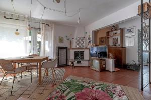 a living room with a table and a dining room at La Maison de Coco in Muzzano