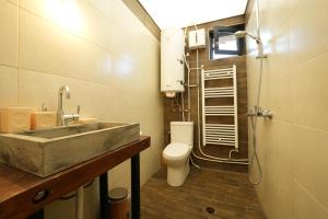 a bathroom with a sink and a toilet at Adventure Camp Emen in Emen +28 photos