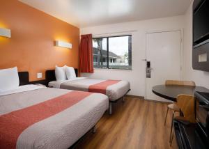 a hotel room with two beds and a table at Motel 6-Pismo Beach, CA in Pismo Beach +44 photos