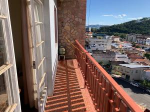 a balcony with a view of a city at Apart 1 Dorm Sala 3 Ambientes in Águas de Lindoia