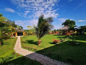 a garden with a pathway leading to a building at SASCHAS PLACE in Siquijor