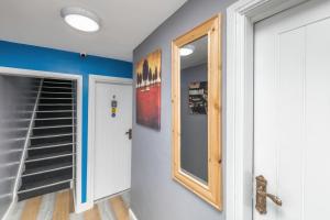 a hallway with a mirror and a stairwell at Stockton town centre studio apartments free parking and Wi-Fi in Stockton-on-Tees