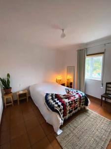 a bedroom with a bed with a blanket on it at CASAS NAS TERMAS in Cabeço de Vide +25 photos