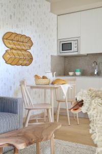 a kitchen with a table with chairs and a dog at Artesa Suites & Spa in Santo Tomé del Puerto