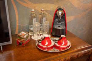 a table with a bottle of wine and a blender at Bey House Royal Hotel in Veliko Tŭrnovo
