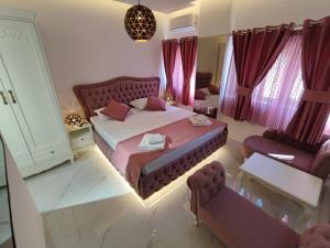 a bedroom with a large bed and purple curtains at Villa Vista Real in Kotor +52 photos